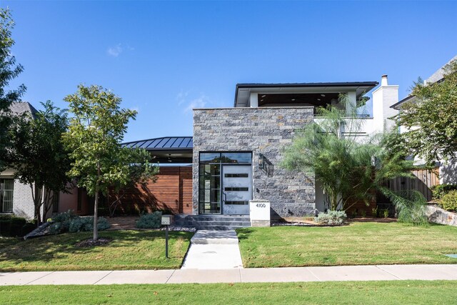 contemporary home with a front yard