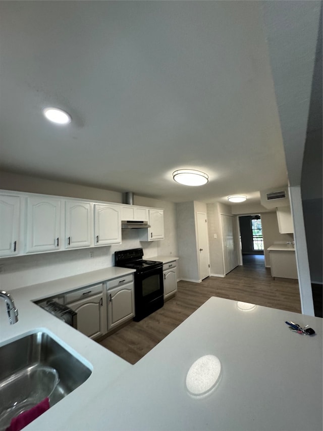 kitchen featuring black range with electric cooktop, white cabinetry, sink, and dark hardwood / wood-style floors