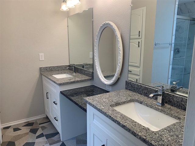 bathroom with vanity, tiled shower, and tile patterned floors