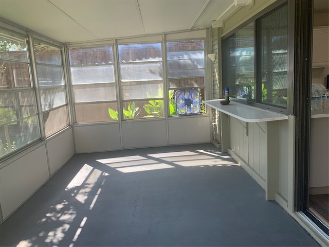 unfurnished sunroom featuring a healthy amount of sunlight