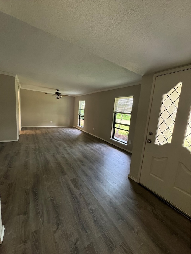 entryway featuring a textured ceiling, dark hardwood / wood-style floors, and ceiling fan