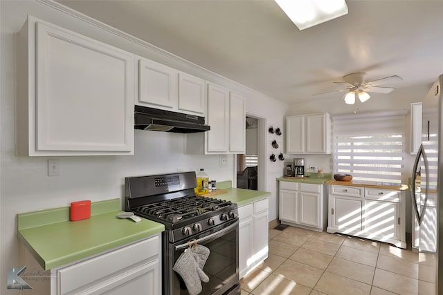 kitchen with ceiling fan, white cabinets, light tile patterned flooring, and stainless steel appliances