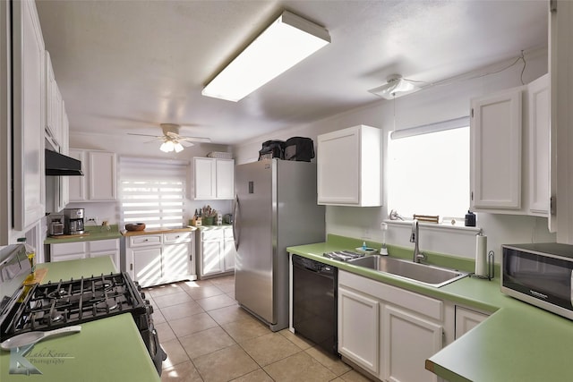 kitchen featuring ceiling fan, stainless steel appliances, light countertops, white cabinetry, and a sink