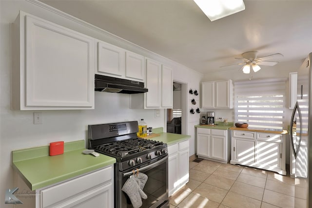 kitchen with stainless steel appliances, white cabinets, light countertops, and under cabinet range hood