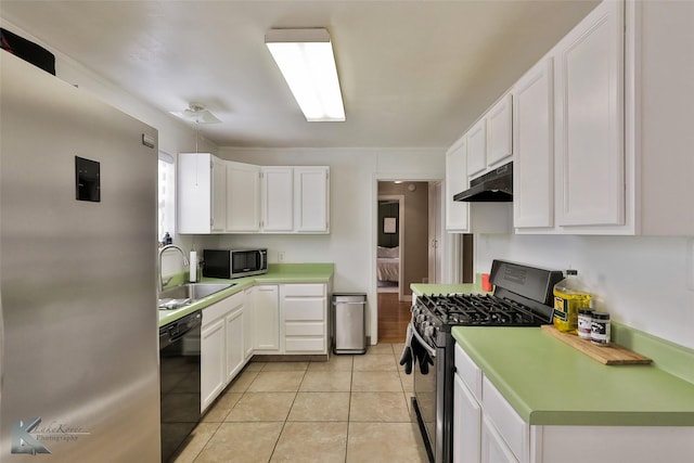 kitchen featuring black appliances, light countertops, and white cabinets