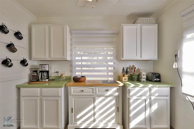 kitchen with white cabinetry and crown molding