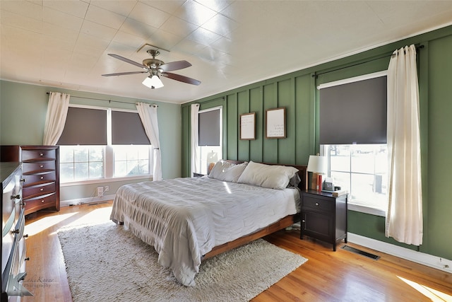 bedroom with light hardwood / wood-style flooring and ceiling fan