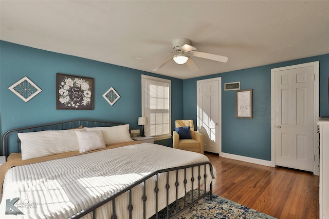 bedroom with ceiling fan and wood-type flooring