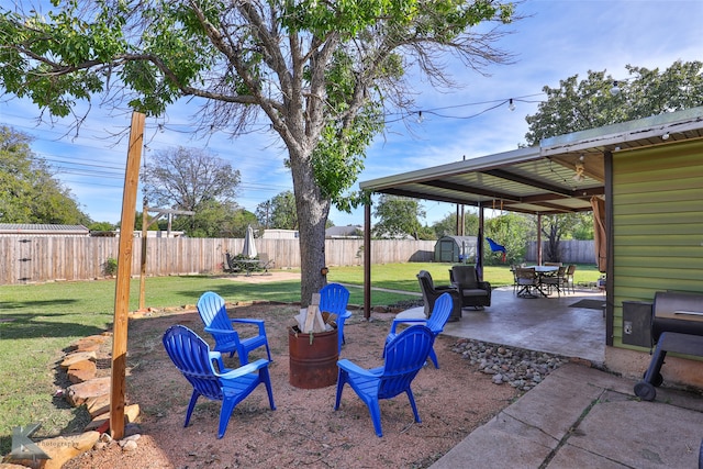 view of yard featuring a patio area and a storage unit