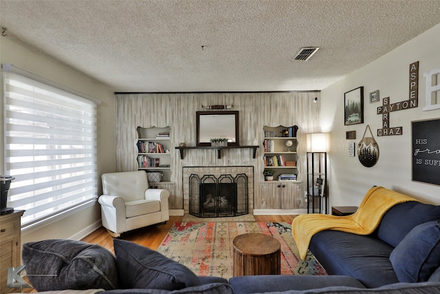 living room with wood-type flooring and a textured ceiling