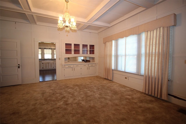 231 N 3rd Ave, Munday, TX 76371 - unfurnished living room with coffered ceiling, a chandelier, beamed ceiling, and carpet floors