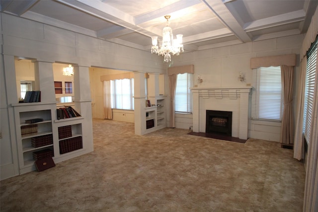 231 N 3rd Ave, Munday, TX 76371 - unfurnished living room with coffered ceiling, a chandelier, a fireplace with flush hearth, beamed ceiling, and carpet