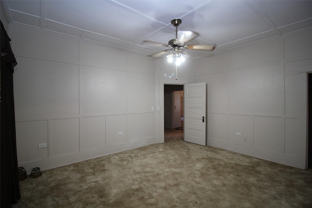 231 N 3rd Ave, Munday, TX 76371 - unfurnished bedroom with a decorative wall, carpet flooring, and ceiling fan