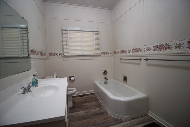 231 N 3rd Ave, Munday, TX 76371 - full bath featuring toilet, wood finished floors, a tub to relax in, vanity, and a wainscoted wall