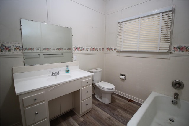 231 N 3rd Ave, Munday, TX 76371 - full bath featuring wainscoting, tile walls, wood finished floors, a tub to relax in, and vanity