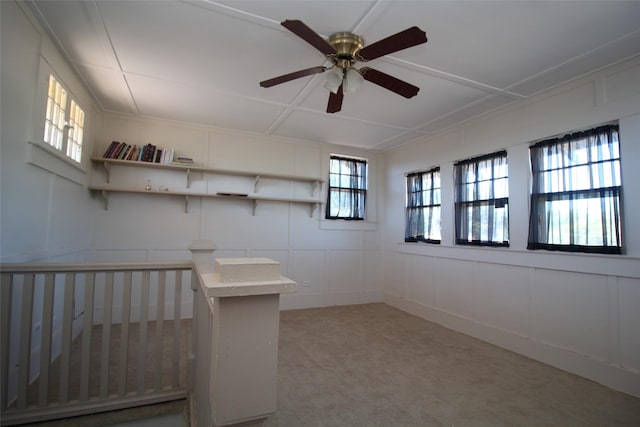 231 N 3rd Ave, Munday, TX 76371 - below grade area featuring a decorative wall, light carpet, and ceiling fan