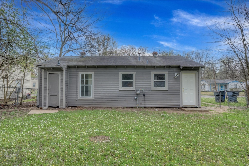 back of property featuring a lawn