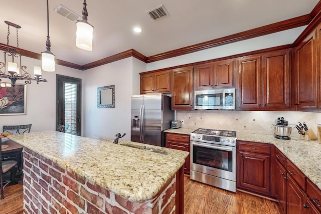 kitchen with a center island, stainless steel appliances, dark hardwood / wood-style floors, crown molding, and pendant lighting