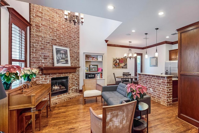 living room featuring a healthy amount of sunlight, light hardwood / wood-style floors, and a chandelier