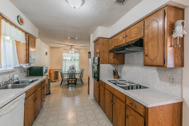 kitchen with sink, white dishwasher, backsplash, and electric cooktop