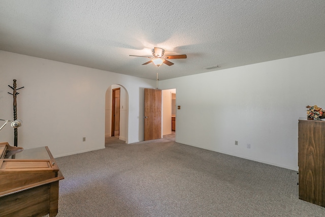 interior space featuring a textured ceiling and ceiling fan