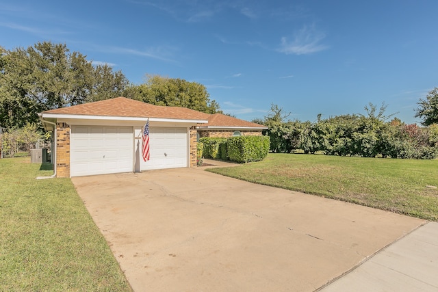 view of front of home with a front lawn and a garage