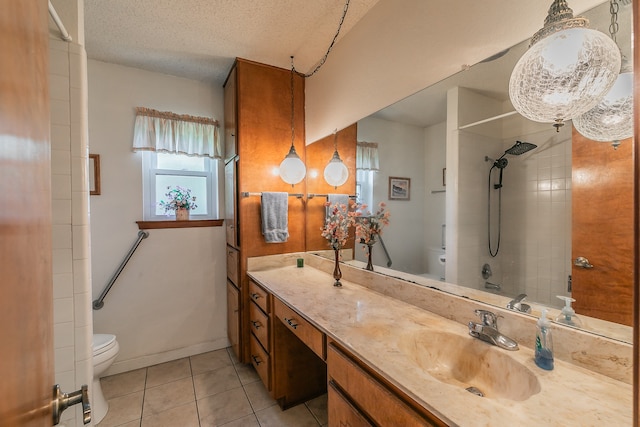 full bathroom featuring tile patterned flooring, a textured ceiling, toilet, vanity, and tiled shower / bath