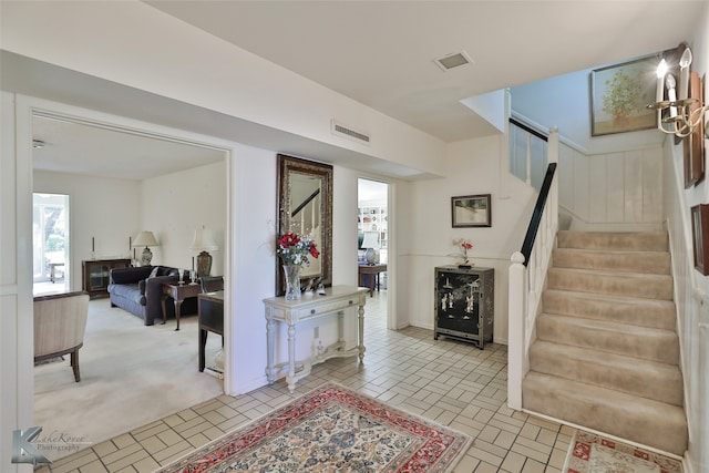 foyer entrance with light colored carpet