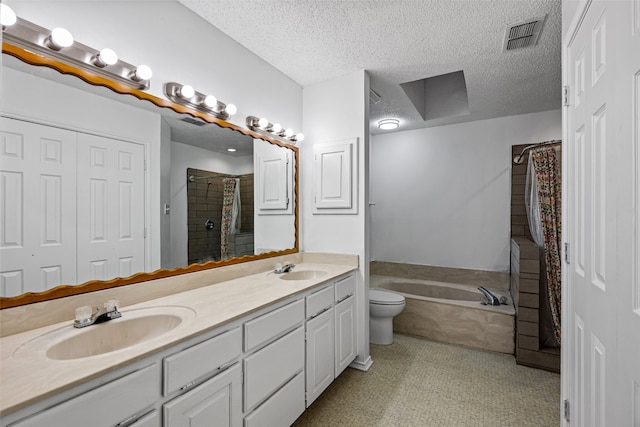 full bathroom featuring vanity, a textured ceiling, separate shower and tub, and toilet