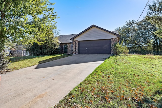 view of front of property with a front lawn and a garage