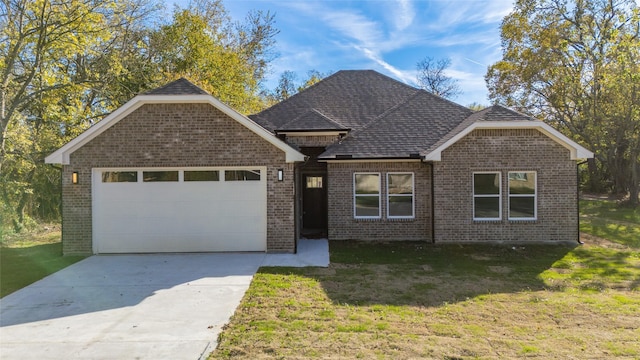 view of front of property featuring a garage and a front lawn