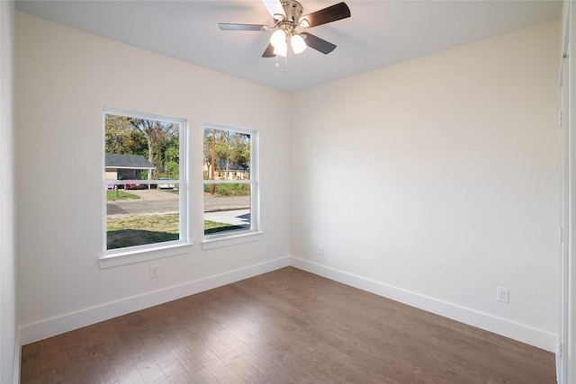 spare room with ceiling fan and dark hardwood / wood-style floors