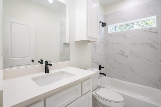 full bathroom featuring vanity, tiled shower / bath combo, and toilet