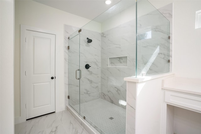 bathroom featuring vanity and an enclosed shower