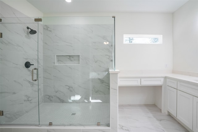 bathroom featuring vanity and a shower with door