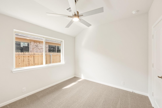 empty room featuring visible vents, baseboards, a ceiling fan, lofted ceiling, and carpet floors