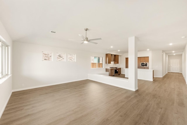 unfurnished living room with light wood-style floors, recessed lighting, visible vents, and baseboards