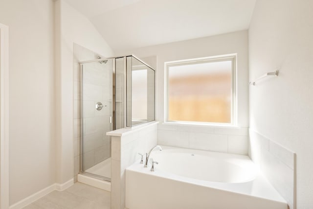 bathroom with a stall shower, tile patterned flooring, and a garden tub