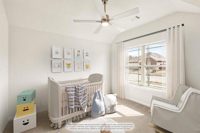 bedroom with lofted ceiling, visible vents, a crib, and carpet