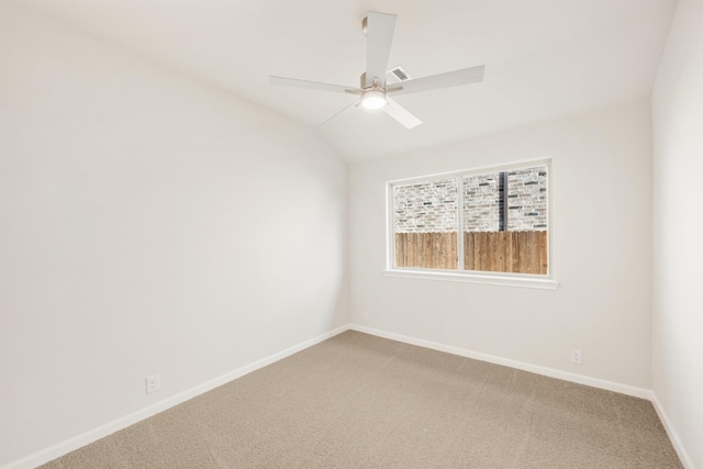 spare room with light carpet, ceiling fan, baseboards, and lofted ceiling