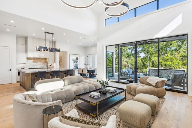 living room featuring a high ceiling and light wood-type flooring