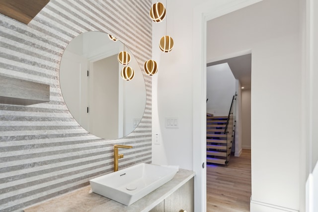 stairs with sink and hardwood / wood-style flooring