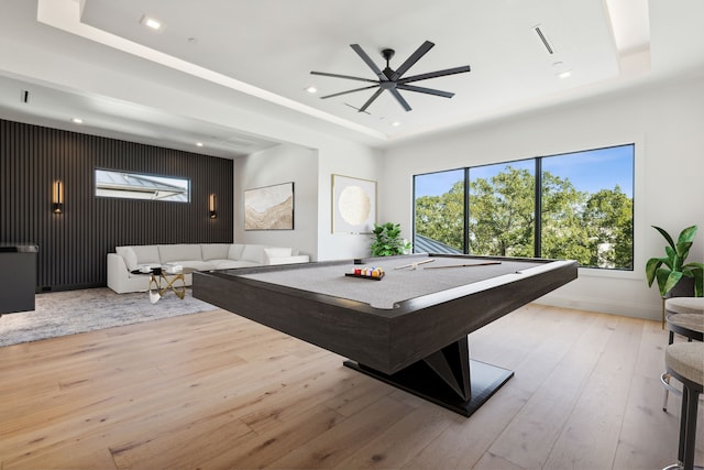 playroom with ceiling fan, billiards, a raised ceiling, and light wood-type flooring