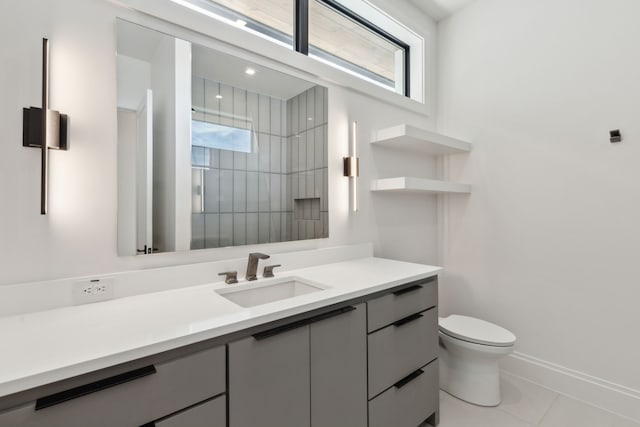 bathroom featuring tile patterned flooring, vanity, and toilet