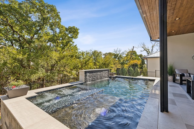 view of swimming pool featuring a jacuzzi