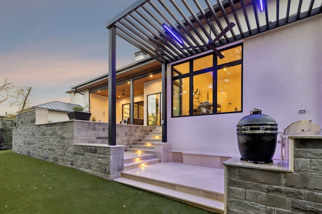 patio terrace at dusk with an outdoor kitchen