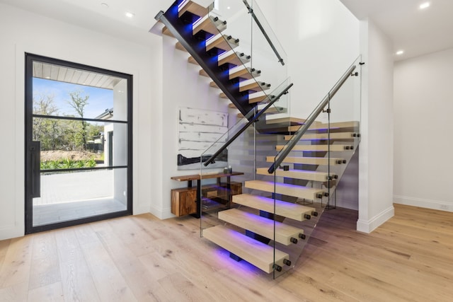 staircase with hardwood / wood-style flooring