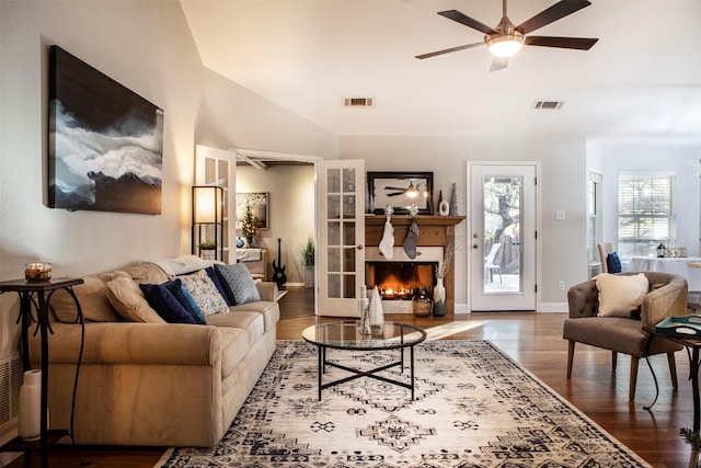 living room with a fireplace, wood-type flooring, and ceiling fan