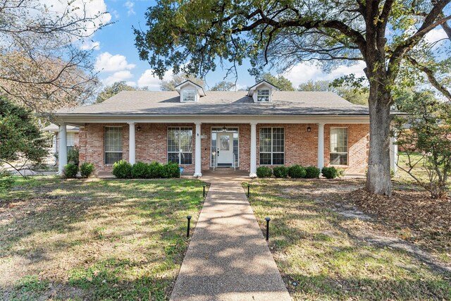 105 Lost Oaks Dr, Waco, TX 76705 - view of front of house featuring a front lawn, covered porch, and brick siding