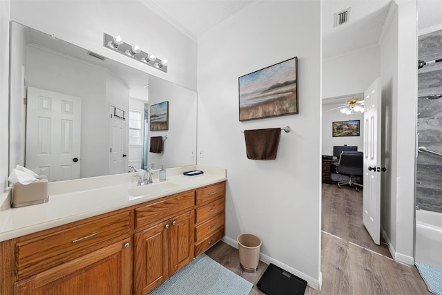 105 Lost Oaks Dr, Waco, TX 76705 - full bathroom with wood finished floors, crown molding, vanity, a ceiling fan, and a bath